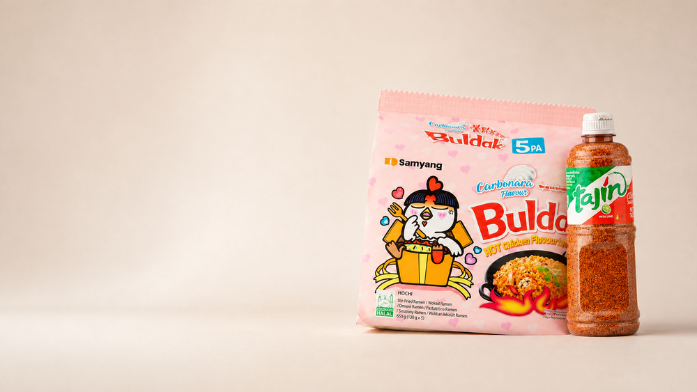 Samyang Carbonara noodles and Tajín seasoning fully visible on a warm studio background