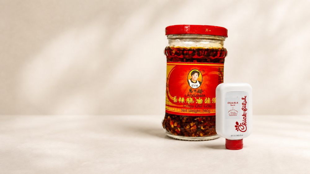 Lao Gan Ma chilli crisp and Chick-fil-A sauce on a warm studio background