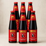 Lee Kum Kee Panda Brand Oyster Sauce 510g, pack of 6, on a warm studio background