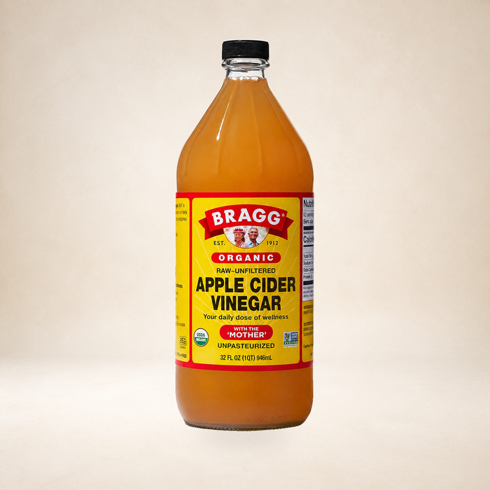 Bragg Apple Cider Vinegar 946ml on a warm studio background