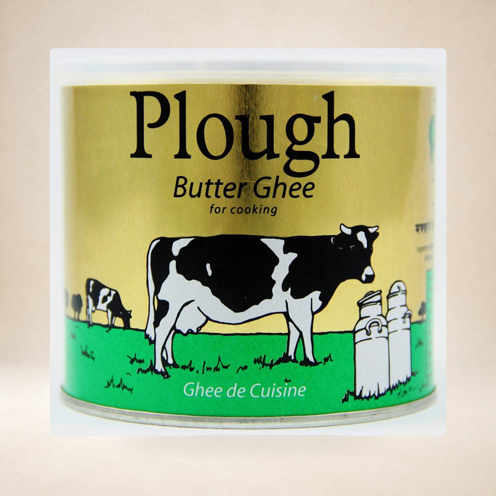 Plough Ghee 500g on a warm studio background