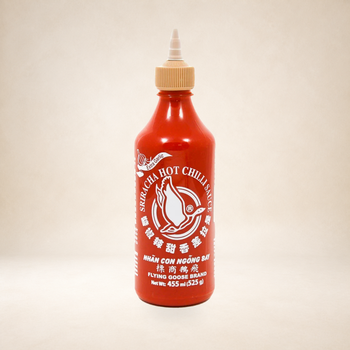 Flying Goose Extra Garlic Sriracha Chilli Sauce 455ml on a warm studio background