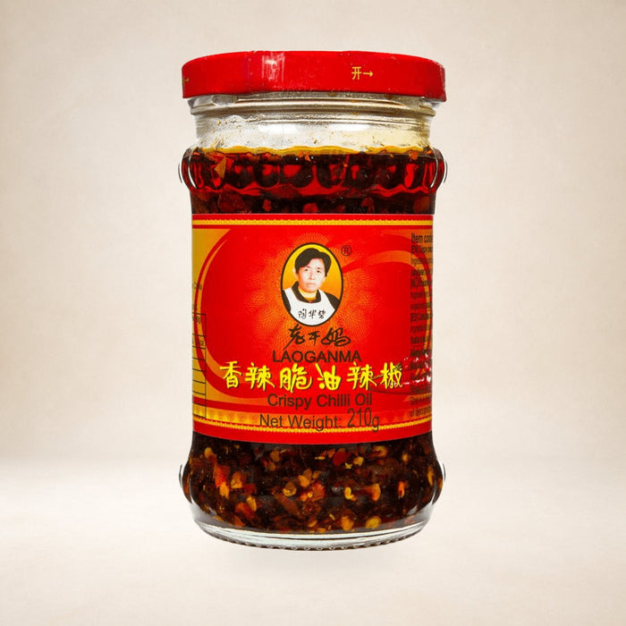 Lao Gan Ma Chilli Crisp 210g on a warm studio background