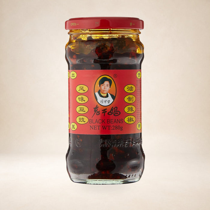 Lao Gan Ma Fermented Soybeans in Chilli Oil 280g on a warm studio background