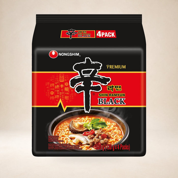 Nongshim Shin Ramyun Black Noodles 4 × 130g on a warm studio background