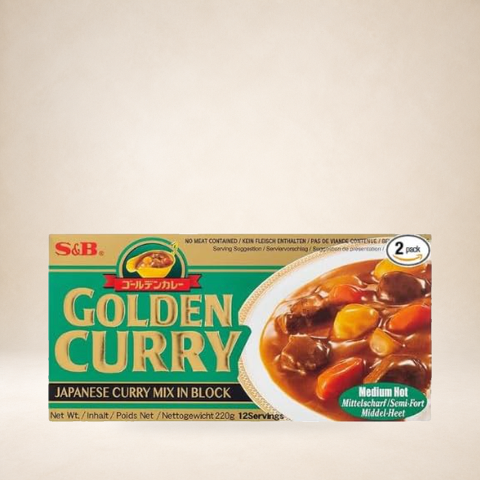 S&B Golden Curry Medium Hot 220g on a warm studio background